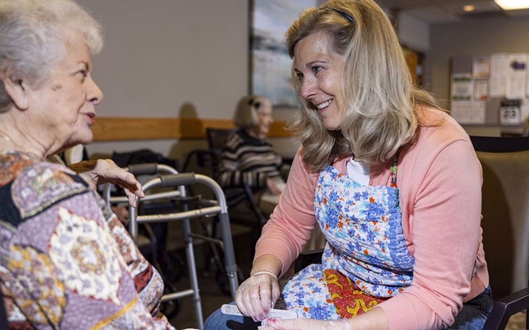 A resident shares a joyful moment with a stylist at the on-site salon at Willow Brook Village in Delaware, Ohio — a small luxury that supports independent and assisted living residents.